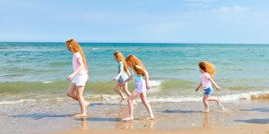 Girls walking along the sand