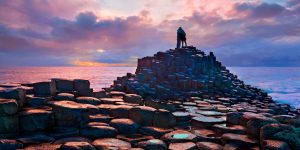 Couple looking out over the ocean standing on the Giant's Causeway