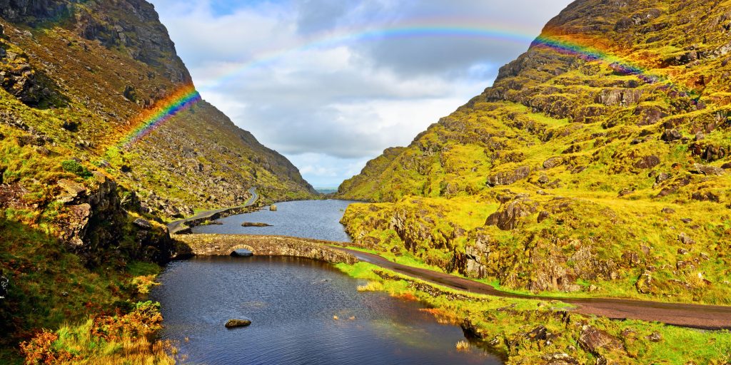 Stone Bridge, river, rainbow with mountains either side
