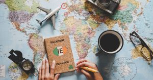 Map, coffee, notepad, hands ready to make notes, reading glasses, model plane