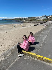 two girls on a promenade by the beach